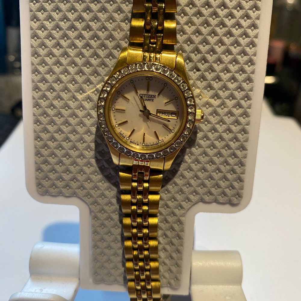 Citizens woman’s watch with faux diamond crystal round shape.